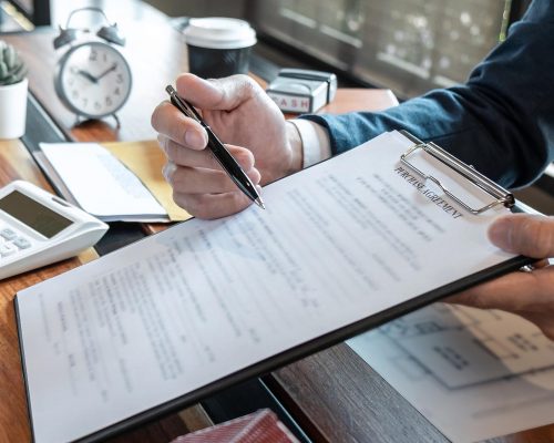 Sale purchase contract to buy a house, Real estate agent are presenting home loan and giving keys to customer after signing contract to buy house with approved property application form.